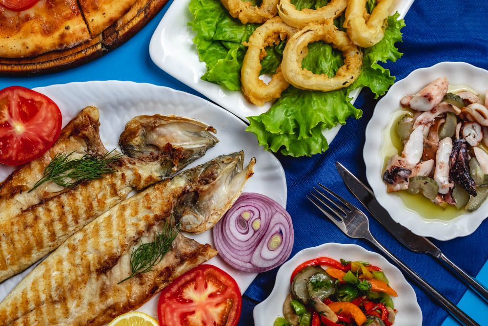 grilled-fish-tomato-onion-calamary-green-salad-top-view